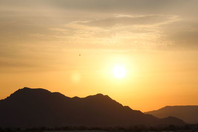 Silhouette mountains against sky during sunset