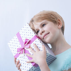 High angle view of girl with gift box against white background