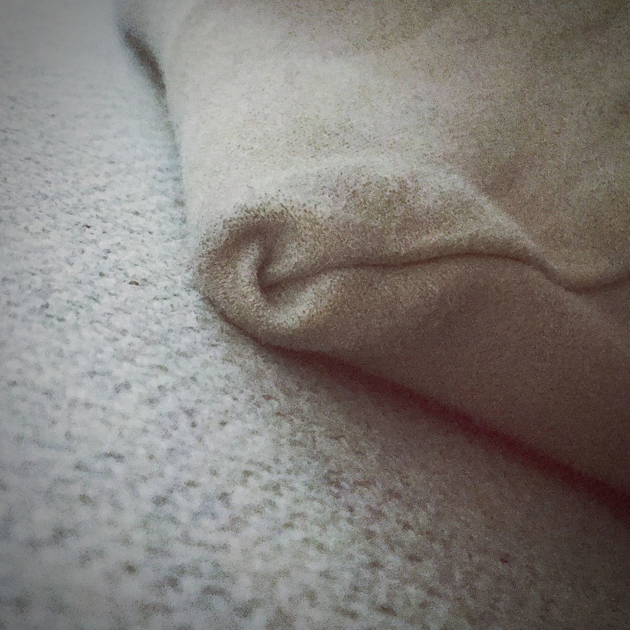 CLOSE-UP OF HAND ON BED