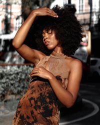 Midsection of woman standing against blurred background