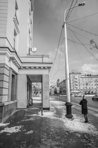 Man in city against sky