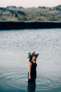 Woman wearing flowers in sea