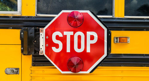 Stop sign on the back of school bus.