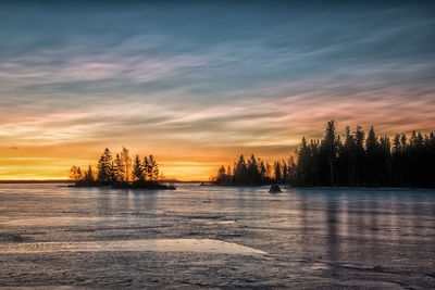 Scenic view of lake against sky during sunset