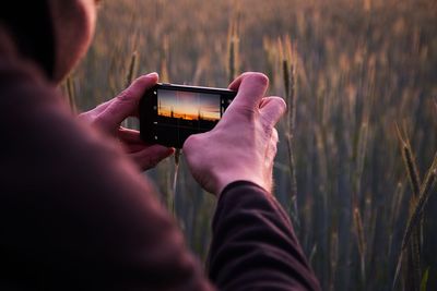 Midsection of man using mobile phone