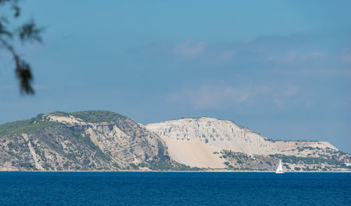 Scenic view of sea and mountains against sky