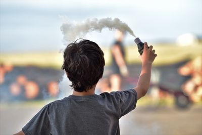 Side view of man photographing with camera