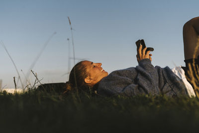 Smiling woman using cell phone