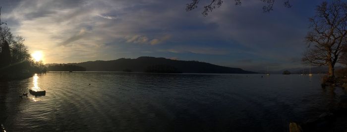 Scenic view of lake against sky at sunset