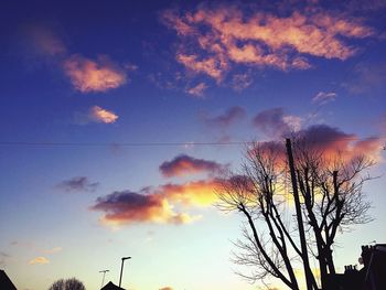 Low angle view of silhouette trees against sky at sunset