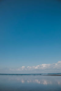 Scenic view of sea against blue sky