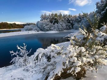 Scenic view of frozen lake against sky during winter