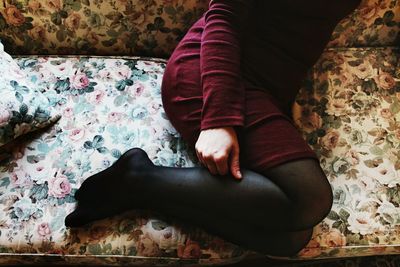Low section of woman on sofa