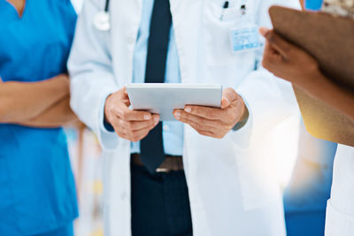 Midsection of doctors working at clinic