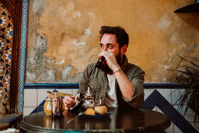 Young man having food in restaurant