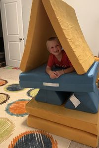 Portrait of boy sitting at home