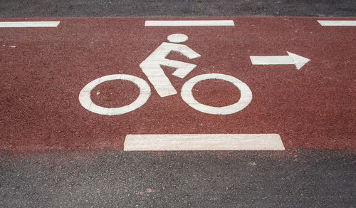 High angle view of bicycle lane sign on road in city