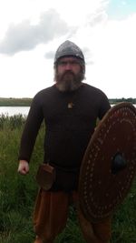 Man standing on field against sky