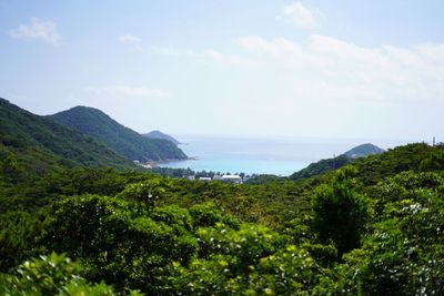 Scenic view of sea and mountains against sky