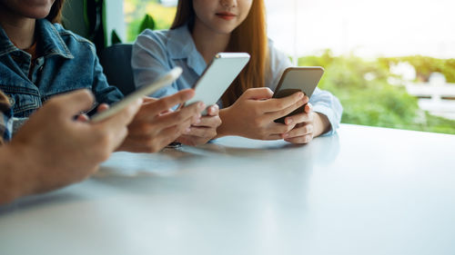 Midsection of woman using mobile phone