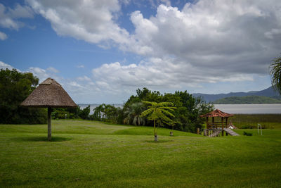 Scenic view of trees and houses against sky