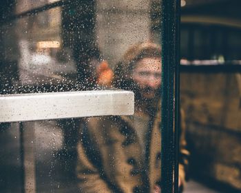 Reflection of man on glass window