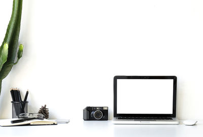 Close-up of laptop on table against white background