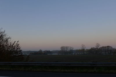 Scenic view of field against clear sky during sunset