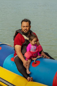 People on inflatable boat in lake