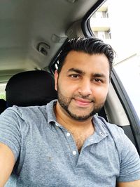 Portrait of man sitting in car