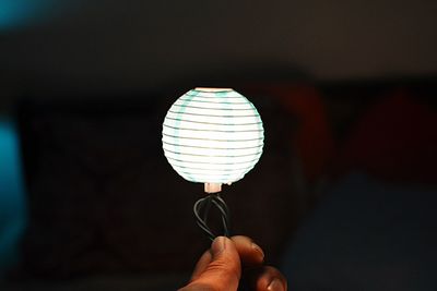 Close-up of hand holding light bulb