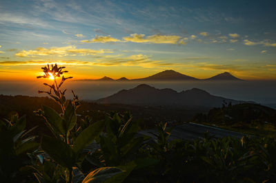 Scenic view of mountains against sky during sunset