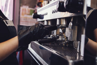 Midsection of man holding coffee