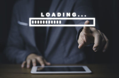 Midsection of man using mobile phone