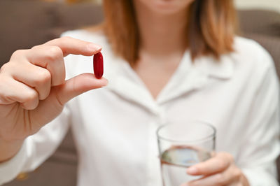 Midsection of woman holding drink