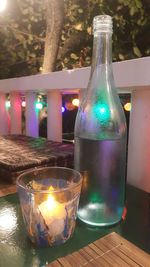 Close-up of illuminated bottle on table