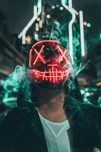 Close-up of man wearing mask standing outdoors