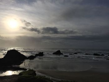 View of beach against cloudy sky