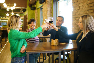 Friends toasting glass in restaurant