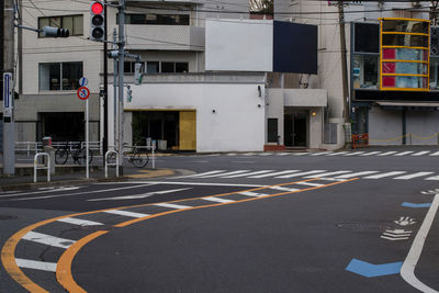 Road sign on street against buildings in city