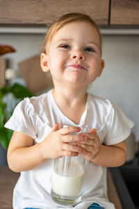 Portrait of cute boy eating food at home