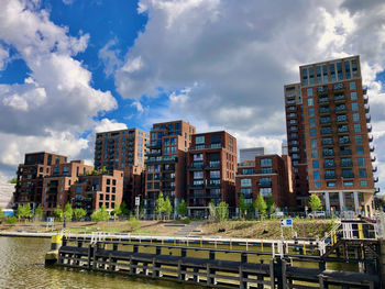 Front view of modern residential complex in ny-warehouse style under summer sky with clouds