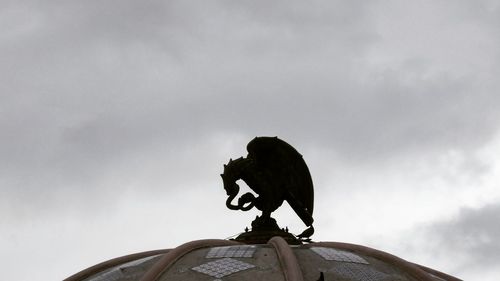 Low angle view of statue against sky