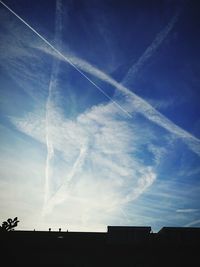 Low angle view of vapor trails in sky