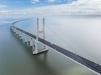 Vasco da gama bridge in lisbon, portugal over the tagus river. drone point of view