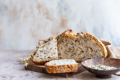 Sliced loaf of artisan sourdough bread with multigrain seeds. tartine with honey and seeds