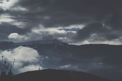 Scenic view of mountains against cloudy sky