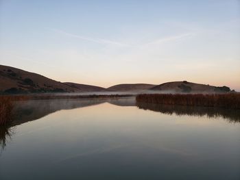 Scenic view of lake against sky during sunset