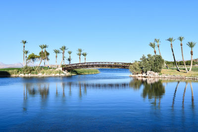 Scenic view of lake against clear blue sky