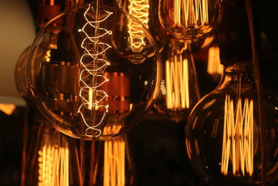 Close-up of illuminated light bulb on table